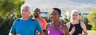 Group of diverse adults jogging outdoors, promoting vitality and wellness with DHEA benefits.
