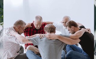 Men in group discussion supporting andropause, sexual health, testosterone support, and joint health.