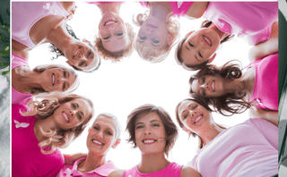 Group of women in pink smiling together, symbolizing unity in women's health, menopause, anti-aging, skin care, and sexual health.