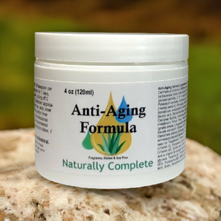 Anti Aging Formula 4oz jar on a stone