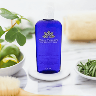 Vital Therapy Antioxidant Toner 4 oz bottle, soy-free and non-GMO, surrounded by fresh plant elements for all skin types.
