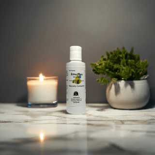 Emu Plus pain relief lotion, soy-free non-GMO plant-based product, with natural ingredients, candle, and plant in background.