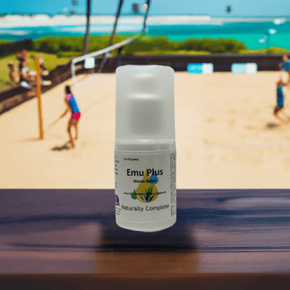 Emu Plus pain relief product with menthol-cajeput oil, soy-free, non-GMO, plant-based formula, in front of a beach volleyball game.