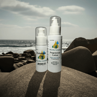Estro Oil and Progesterone Lotion set on rocks by the ocean, featuring soy-free, non-GMO, plant-based ingredients for menopause relief.