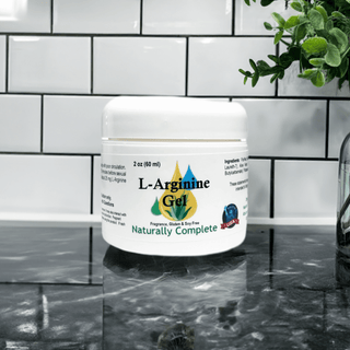 L-Arginine Gel jar on a marble counter with white tile backsplash and green plant, 2 oz size, fragrance and gluten free.