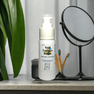 Estrogen cream bottle on a vanity with mirror, soy-free, non-GMO, plant-based, natural menopause relief, made in the USA.