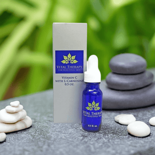 Vitamin C Serum with Caffeine and L-Carnosine 0.5 oz bottle, skincare product in natural stone setting.