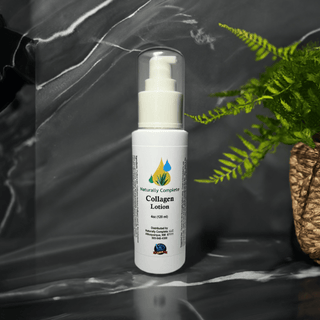 Naturally Complete Collagen Lotion 4oz bottle on a marble background with a plant, soy-free, non-GMO, plant-based skincare.