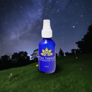 Blue bottle of Vitamin A Complex Nighttime Serum on grass under night sky, skincare product made in the USA for anti-aging benefits.