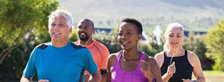 Group of diverse adults jogging outdoors, promoting vitality and wellness with DHEA benefits.