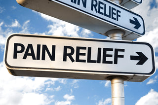 Sign pointing towards pain relief for joint health, muscle relaxation, and headache relief against a blue sky background.