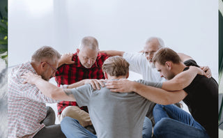 Men in group discussion supporting andropause, sexual health, testosterone support, and joint health.
