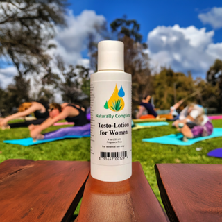 A 4 oz. Bottle of Testo-Lotion for Women o a bench watching a yoga class in the park