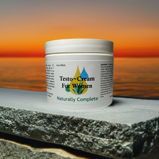 a 4 oz. Jar of Naturally Complete Testo-Cream for Women on a stone overlooking a sunset on the water
